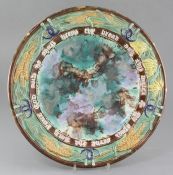 A Victorian majolica bread dish, late 19th century, with a motto, wheatsheaf and sickle border,