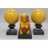An Art Deco style composition group of a sphinx and two spheres