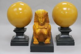 An Art Deco style composition group of a sphinx and two spheres
