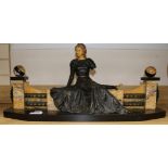An Art Deco spelter and marble girl on a a bench
