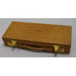 A crocodile skin jewellery case, early 20th century, fitted brass Chubb locks, the hinged