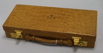 A crocodile skin jewellery case, early 20th century, fitted brass Chubb locks, the hinged