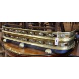 A Regency pierced and embossed brass fender W.110cm