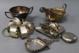 A set of six silver engine-turned napkin rings, a silver pocket watch, sauce boat, sugar bowl and