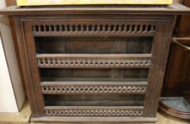 An 18th century French provincial walnut hanging wall shelves W.134cm