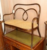 A late Victorian child's bentwood caned seated settee W.85cm