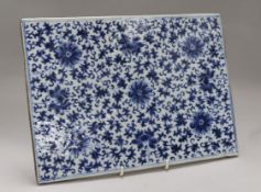 A Chinese blue and white large rectangular tile, decorated with an all-over pattern of flowers and