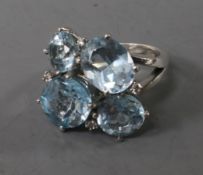 A silver, blue topaz and colourless stone set dress ring, size L.