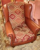 A leather and tapestry upholstered armchair