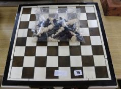 A 1930's ivory and tortoiseshell chess board and a 19th century ivory chess and draughts sets