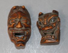 A Japanese Meiji carved wood Noh mask netsuke of Hannya and another similar