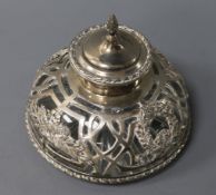 A circular cut glass silver-mounted inkwell, the heavy inkwell with star-cut base, the pierced mount