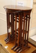 A nest of four Edwardian inlaid mahogany oval tables W.52cm