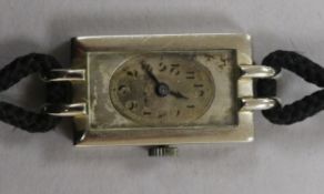A lady's 18ct white gold Rolex rectangular dial manual wind wrist watch.