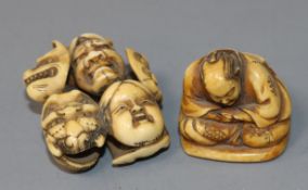 A Japanese ivory netsuke carved with nine Noh masks and another of a seated man asleep, both