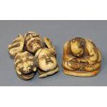 A Japanese ivory netsuke carved with nine Noh masks and another of a seated man asleep, both