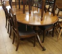 A Regency style mahogany twin pillar dining table and eight chairs, (6 plus 2 carvers). W.213cm with