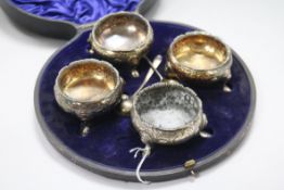 A matched set of four 18th century later embossed silver bun salts, in case with two associated
