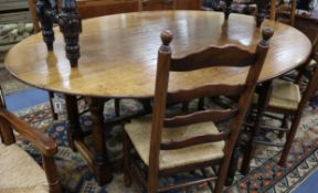 A 17th century style oak double gateleg table W.210cm.