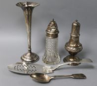 A George III silver fish slice, an engraved and embossed silver sugar caster and three other