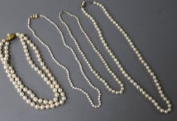 Four assorted cultured pearl necklaces including double strand with 9ct gold clasp.