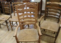 A set of five ash ladderback, rush seated dining chairs