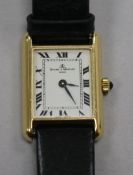 A lady's 18ct gold Baume & Mercier rectangular dial manual wind wrist watch.