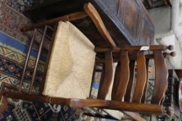 A set of eight ladderback rush seat oak dining chairs