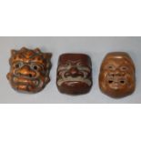 Three Japanese Meiji carved wood Noh mask netsukes, various, all signed