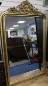 A 19th century French giltwood and gesso wall mirror, with moulded frame and foliate scroll crest,