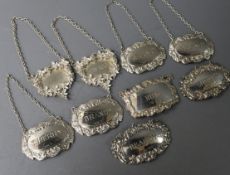Nine assorted silver wine labels, including a set of four 1960's, a 1970's pair and a pair with