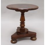 A Victorian miniature mahogany circular topped dining table