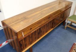Robert Heritage for Archie Shine, a rosewood sideboard, fitted four short drawers over two sliding