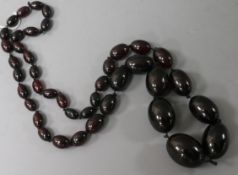 A single strand graduated simulated cherry amber necklace, 70cm, gross 71 grams.