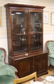 A 19th century mahogany bookcase, enclosed by a pair of glazed doors over a pair of panelled doors