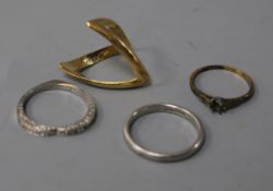 An 18ct gold triangular ring, another 18ct gold ring (a.f) and two platinum rings