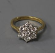An 18ct gold and diamond cluster ring, size H.