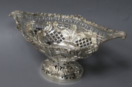 A George V ornate silver sweetmeat dish, of oval pedestal form with scrolled foliate handles to