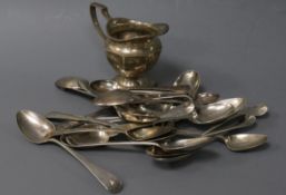 A small quantity of silver teaspoons and a silver cream jug.