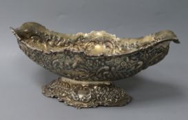 A late Victorian embossed silver oval pedestal fruit bowl, Goldsmiths & Silversmiths, London,