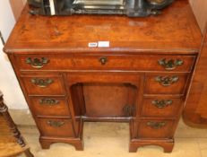 A George III banded walnut kneehole desk W.76cm