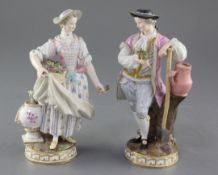 A pair of Meissen porcelain figures of gardeners, late 19th century, underglaze blue crossed