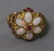 A 1970's 9ct gold, white opal and ruby cluster dress ring, size M.