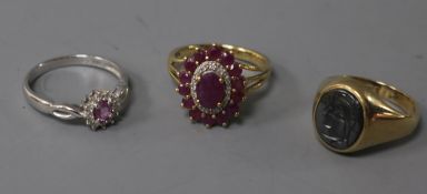 A 9ct white gold, pink sapphire and diamond cluster ring, another cluster ring and a 9ct yellow gold