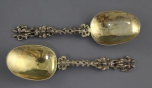 A pair 19th century continental silver gilt spoons with figural terminals, pierced spiral stems