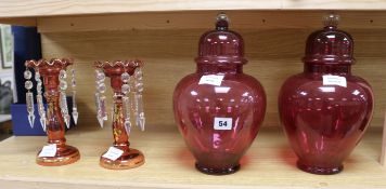 A pair of Victorian gilt cranberry glass lustre hung vases and a pair of cranberry glass lidded