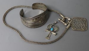 Three items of Islamic white metal jewellery, including bangle and pendant.