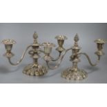 A pair of two branch silver plated candlesticks