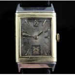 A 1930's 18ct gold and stainless steel Le Coultre Reverso manual wind wrist watch, the rectangular