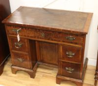 A Georgian style walnut kneehole desk fitted leather skiver W.84cm